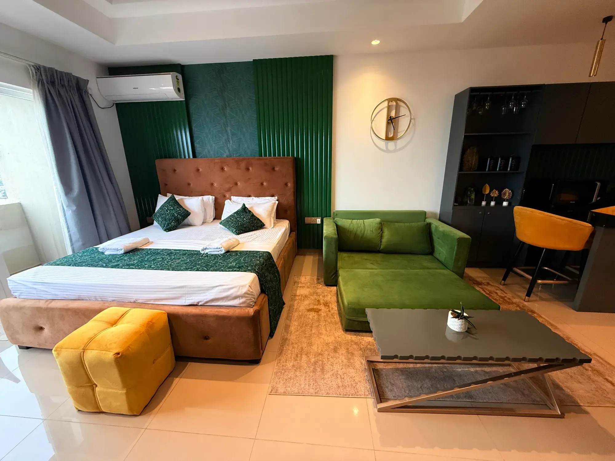 Bed and green sofa with a coffee table