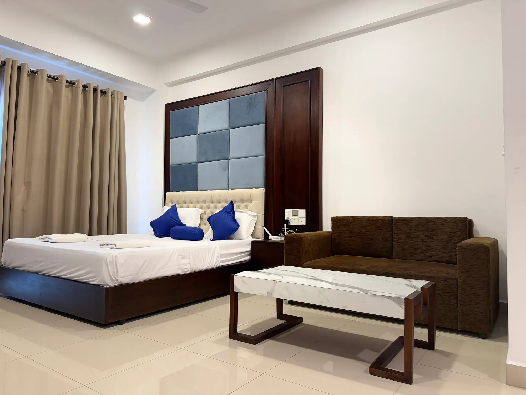 Bed and sofa with a marble-topped table