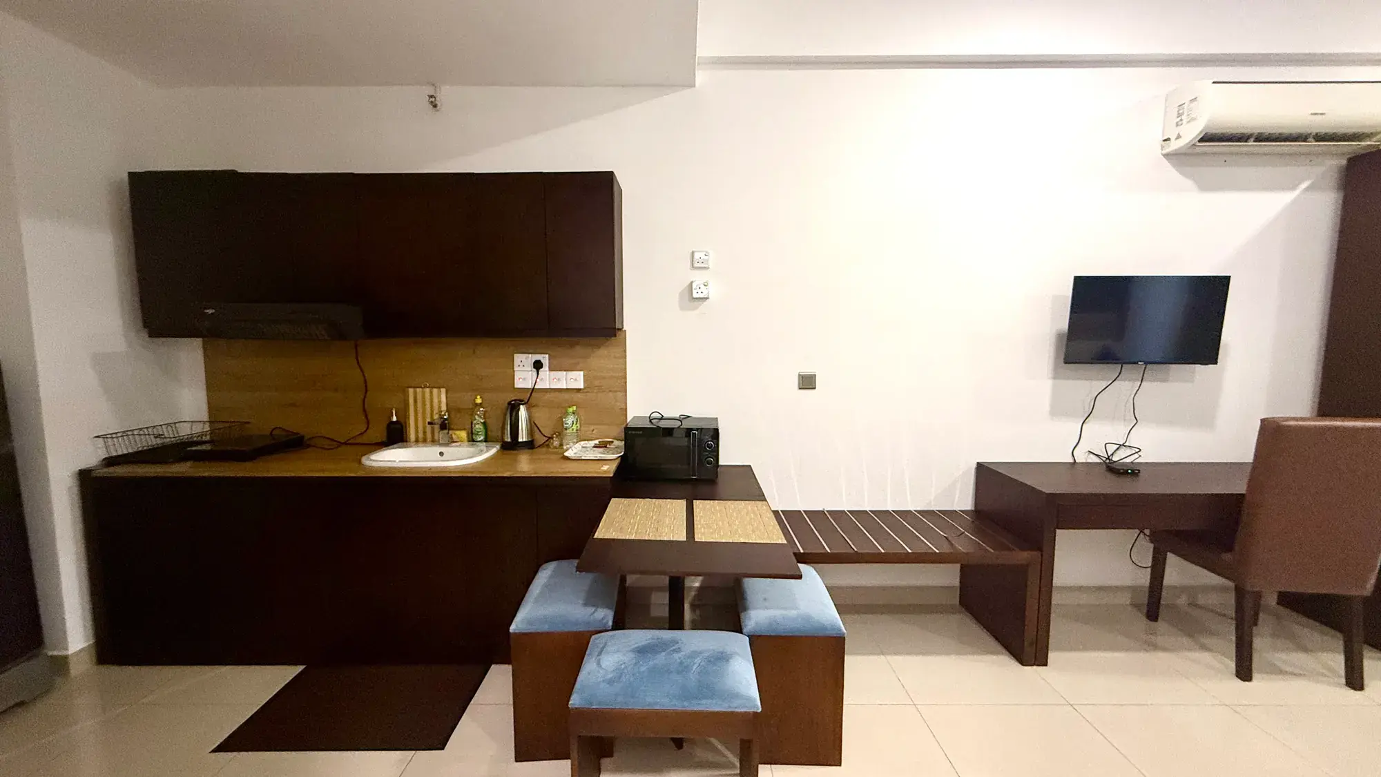 Kitchenette with a small dining table and a desk