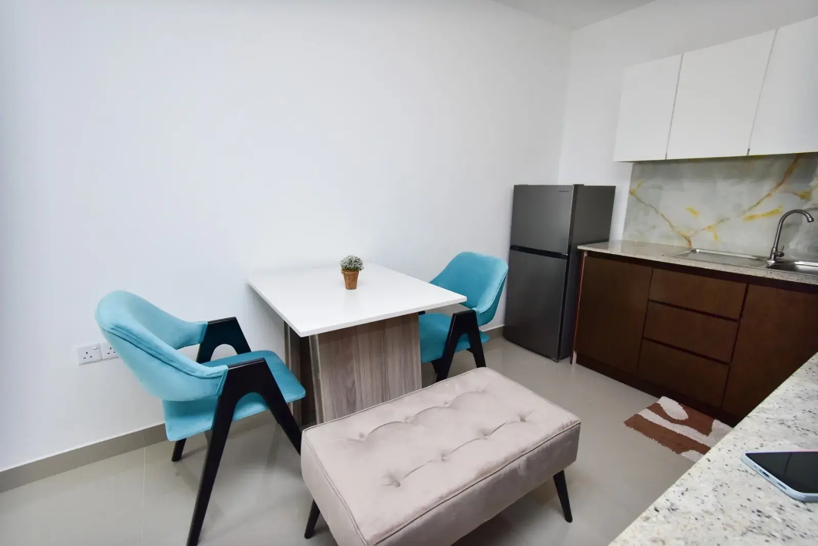 Dining table with two chairs by the kitchen