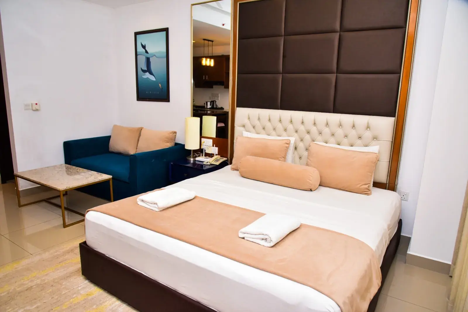 Bedroom with a sofa and a padded headboard
