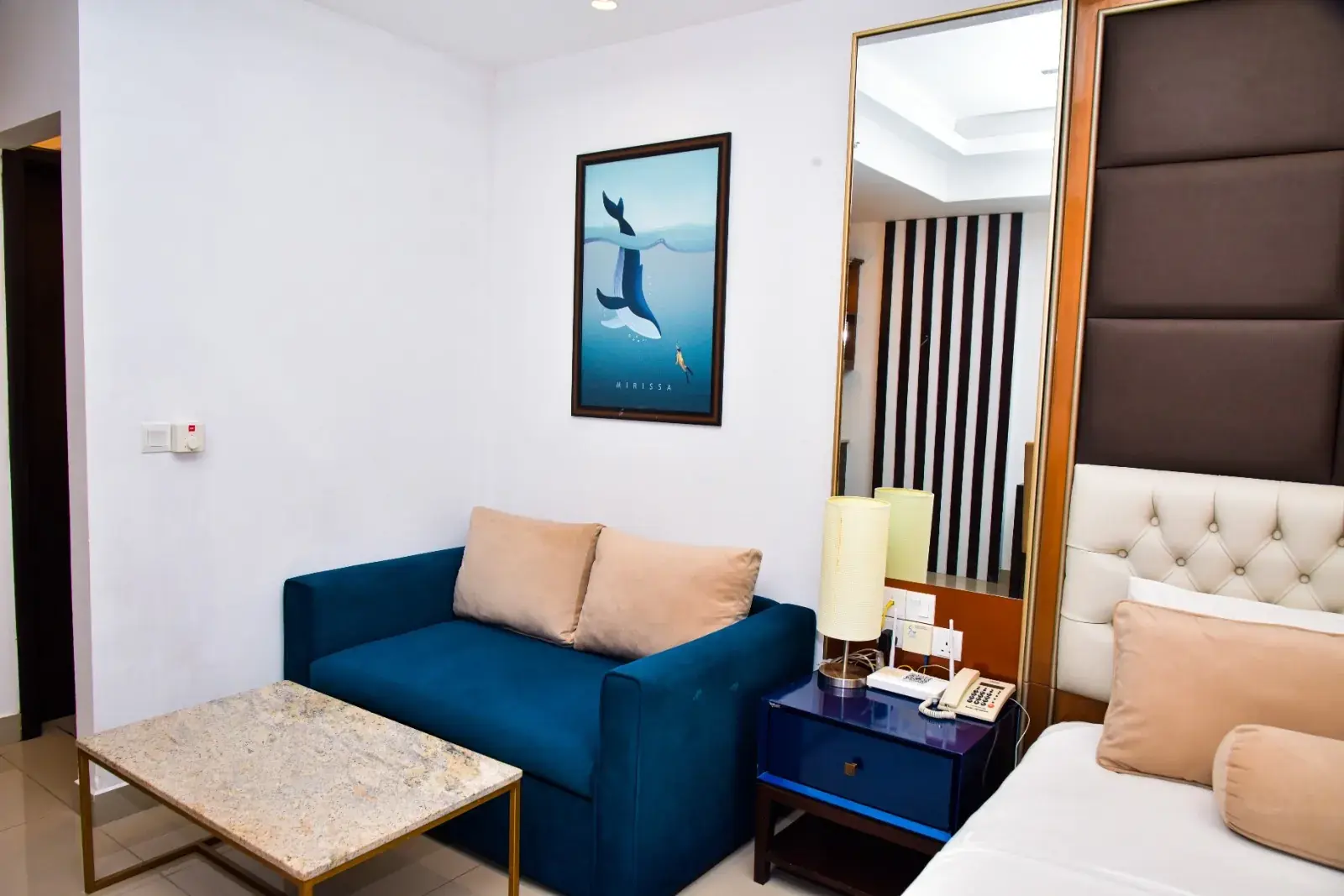 Blue sofa beside the bed