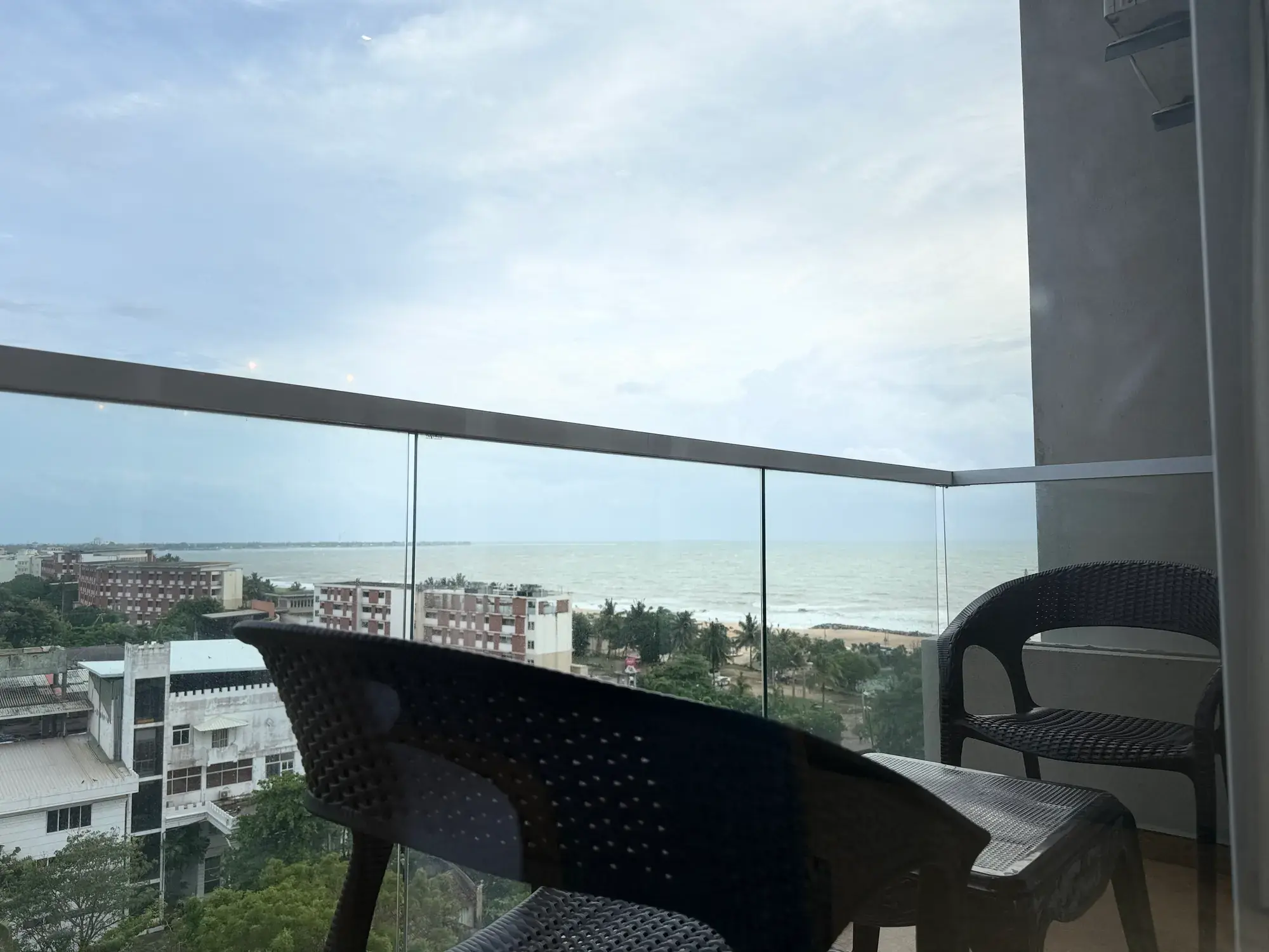 Balcony chairs behind a glass railing