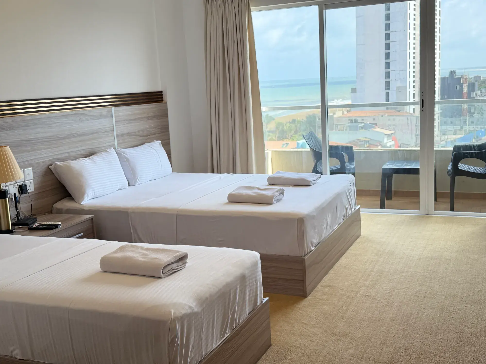 Room with two beds and balcony doors