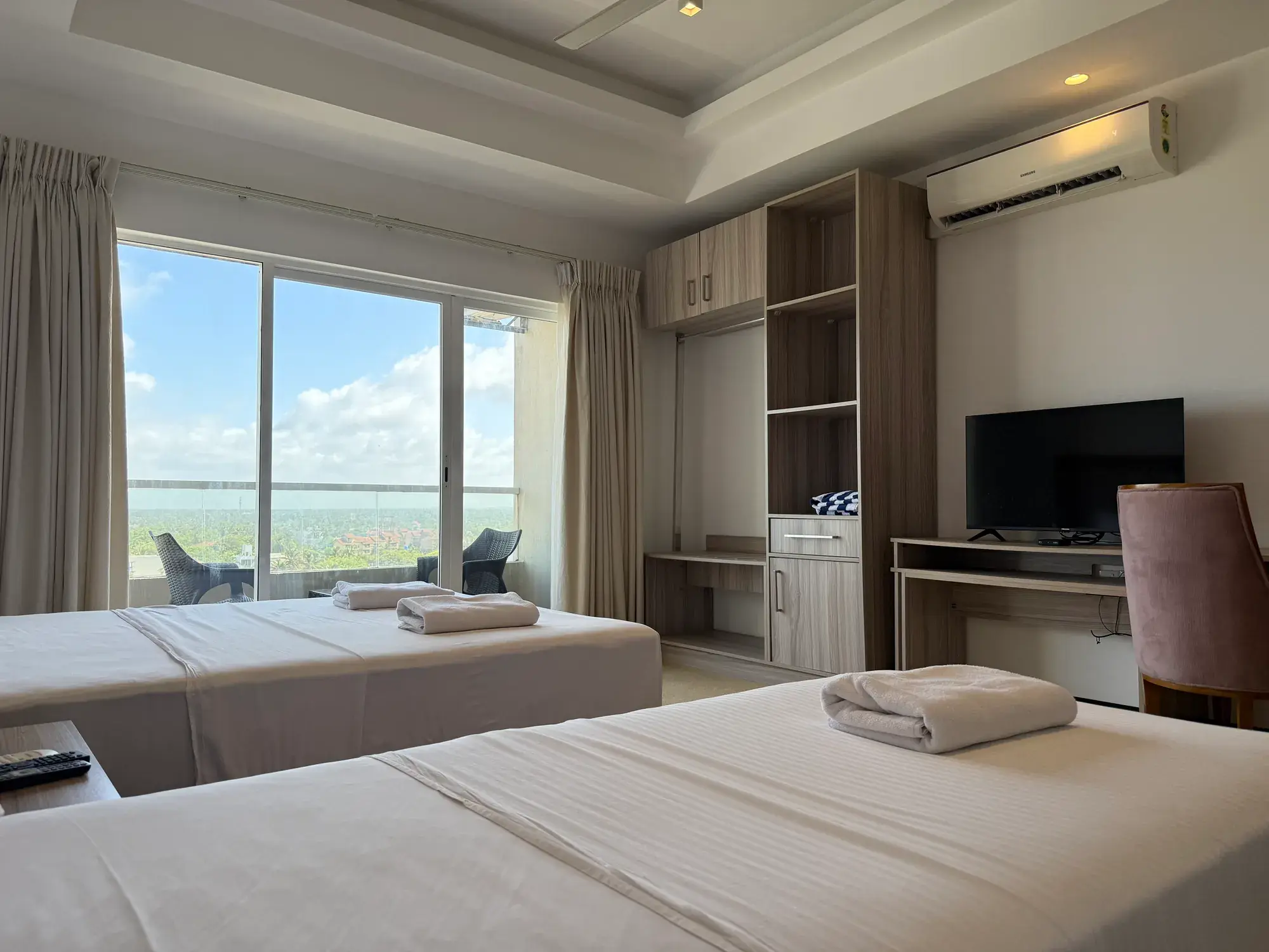 Two beds with the TV and desk opposite