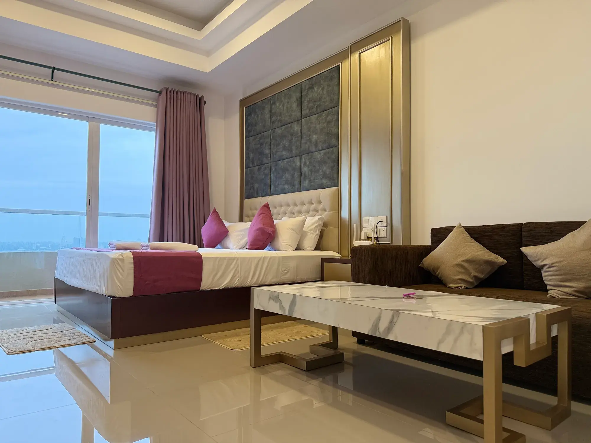 Bed, sofa and coffee table by the windows