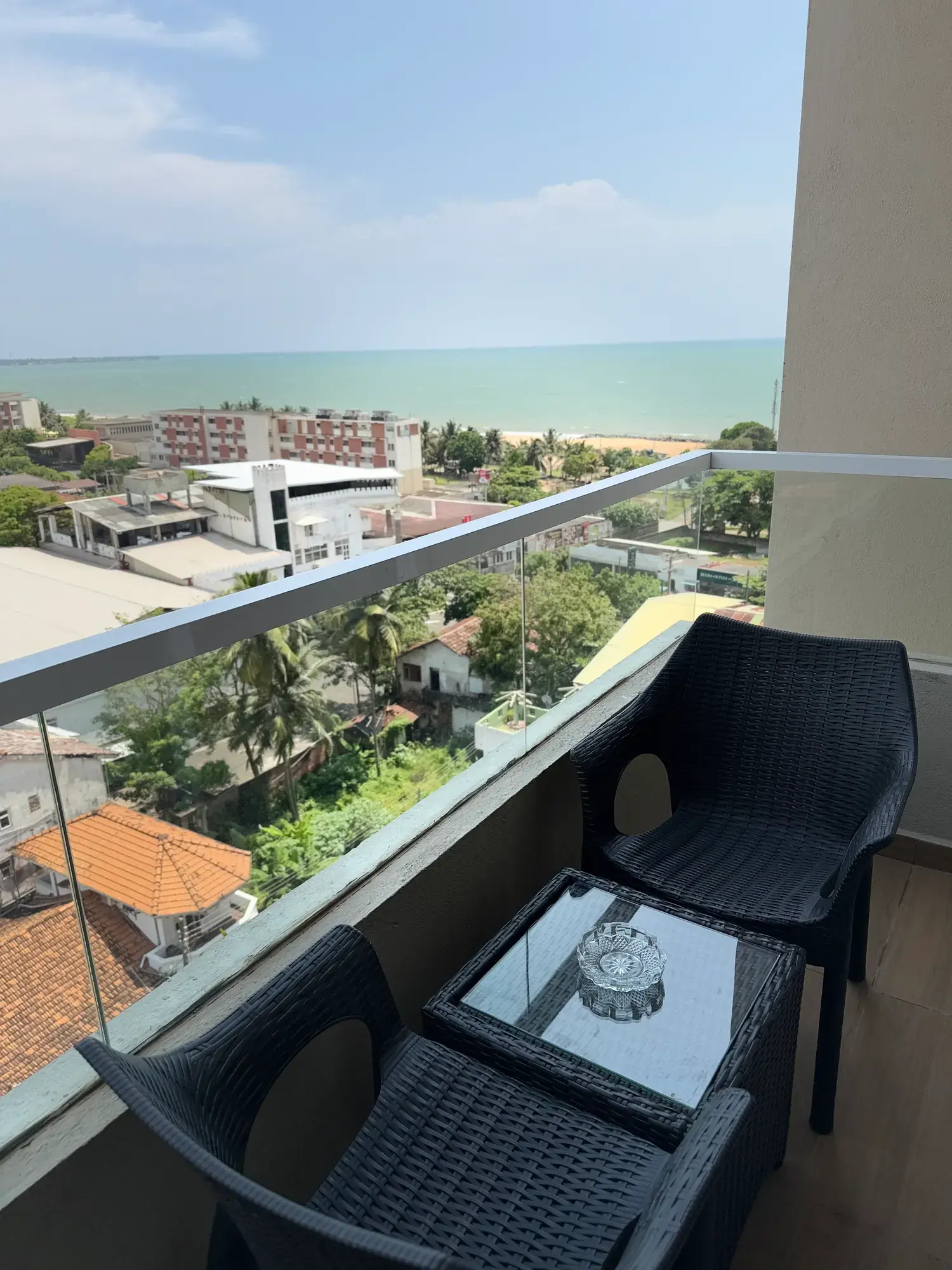 Balcony chairs behind a glass railing