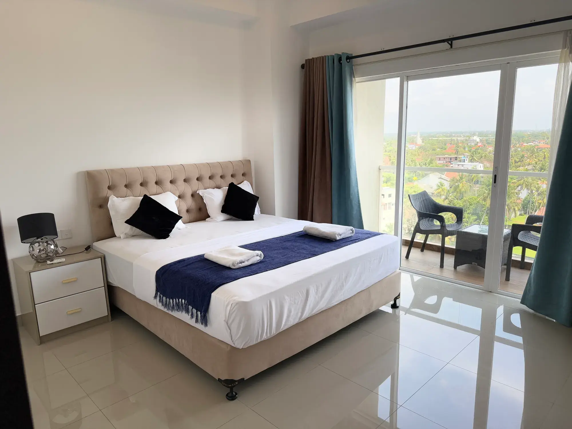 Double bed beside the balcony doors