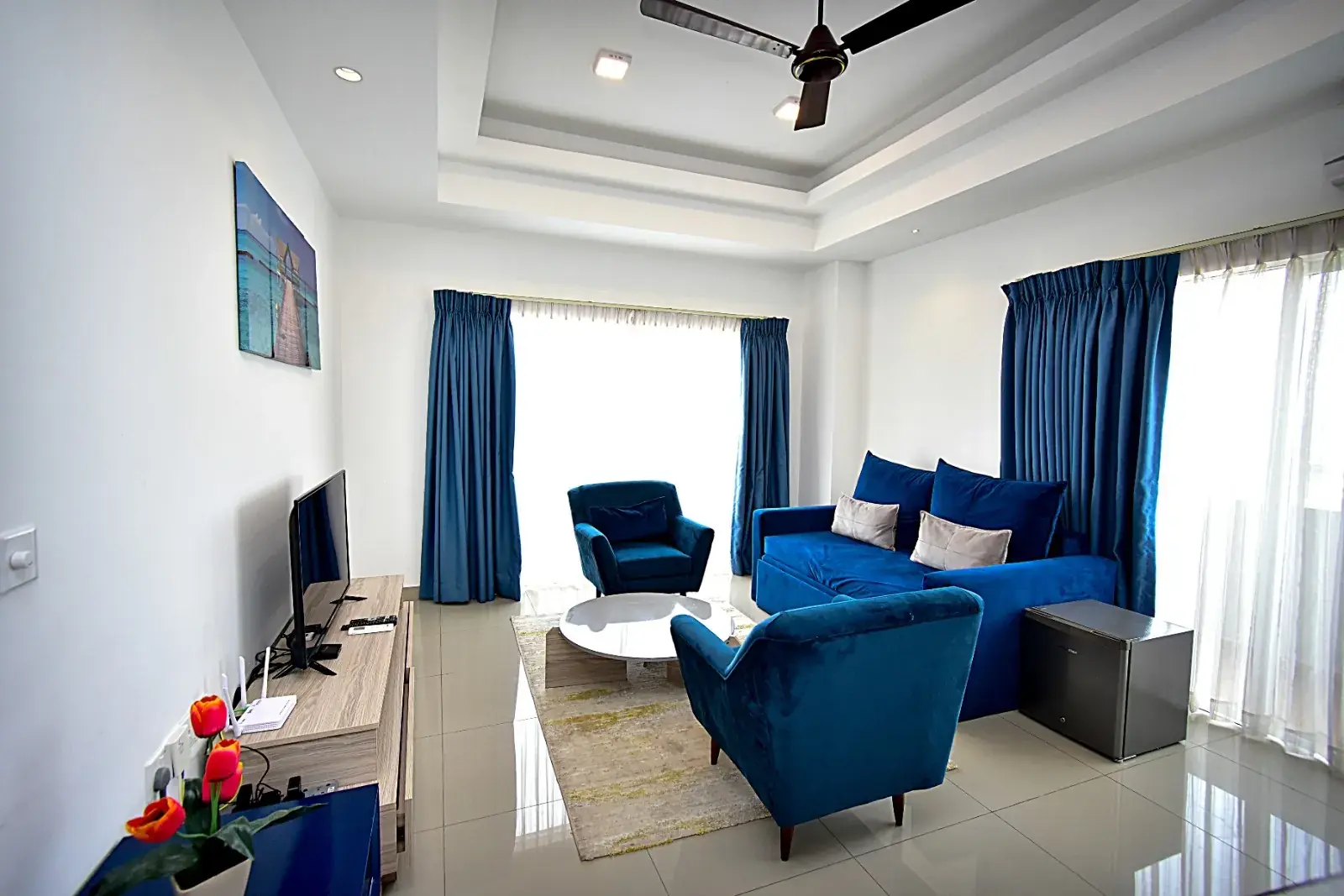 Living room with a TV and armchairs